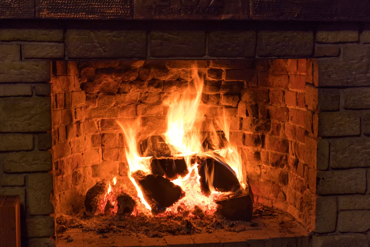 A wood fire burning in a brick fireplace
