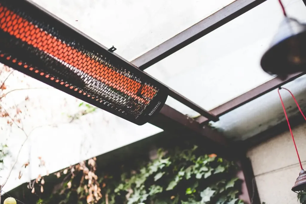 A Bromic infrared patio heater mounted under a pergola