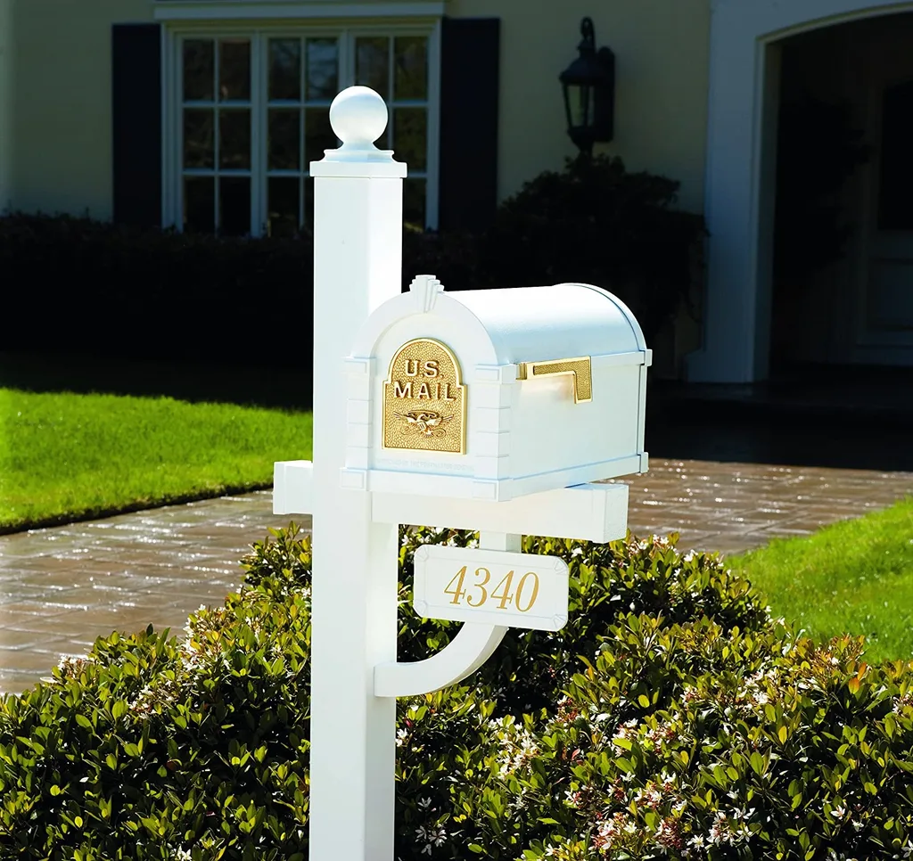 A white Gaines post mailbox with a gold address plaque