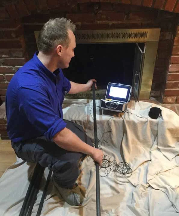A Bowden's technician camera-scoping a firebox during a Level 2 inspection